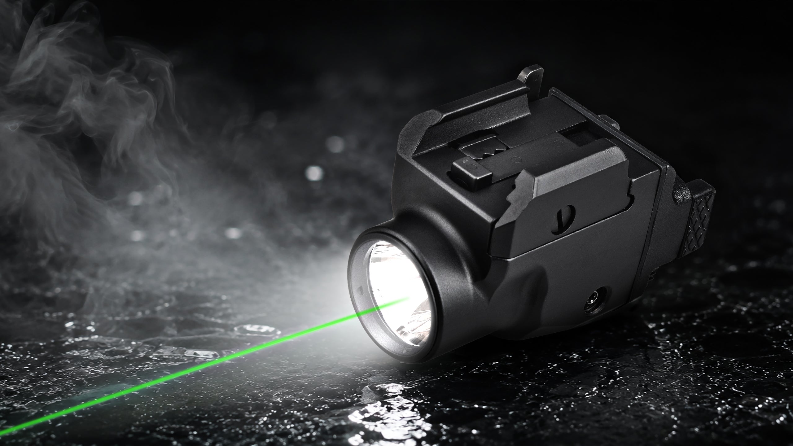 A tactical black flashlight emitting a bright green laser beam across a dark, wet surface with visible mist and reflections.